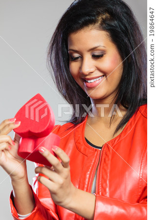 Girl in red holding heart gift Girl in red holding heart gift 19864647