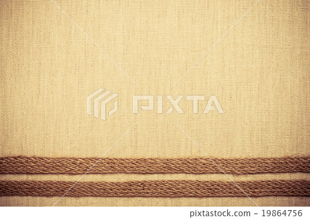 Jute ribbon on linen cloth background Jute ribbon on linen cloth background 19864756