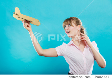 woman thinking about vacation holds airplane woman thinking about vacation holds airplane 19864847