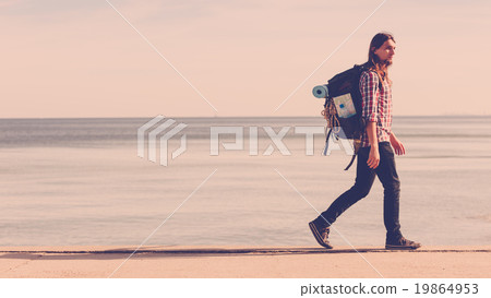 Man hiker with backpack tramping by seaside 19864953