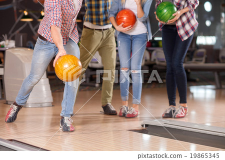 Cute four friends are playing kegling together 19865345