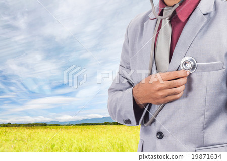 Business man using stethoscope checking his heart Business man using stethoscope checking his heart 19871634