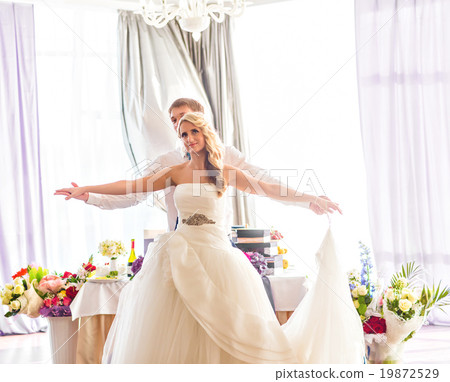 Happy bride and groom on their  wedding reception 19872529