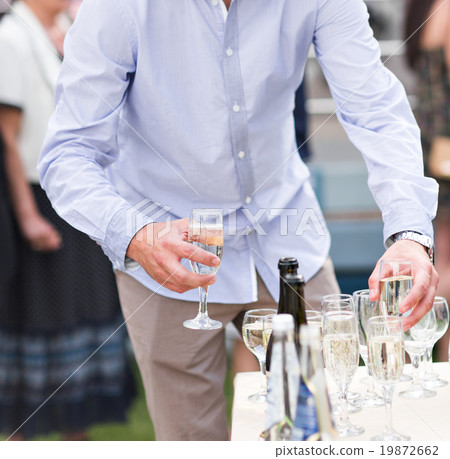 Wedding guest holding glass of champagne closeup Wedding guest holding glass of champagne closeup 19872662