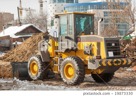 Tractor removes debris from building demolition Tractor removes debris from building demolition 19873330