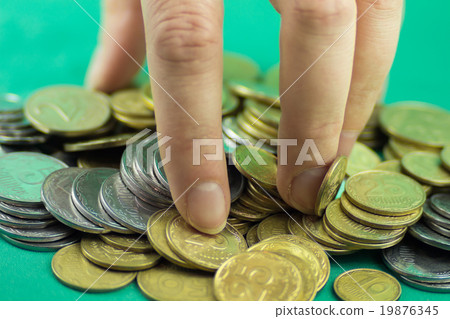 Lots of coins different values with human hand 19876345