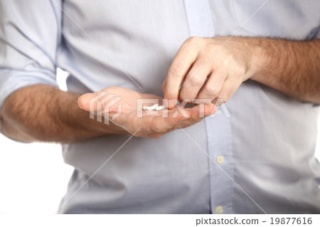 Man in blue shirt takes pills 19877616