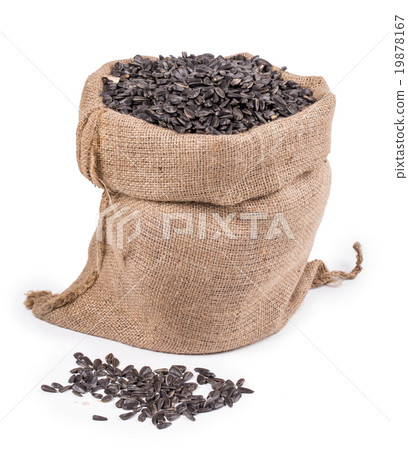 Close up of black sunflower seeds in bag. 19878167