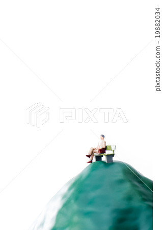 A businessman sitting on a bench sadly 19882034