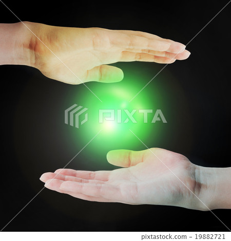 A light ball floating in the human hand 19882721