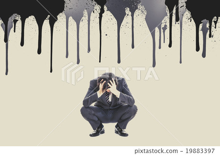 A businessman holding a head and squatting down A businessman holding a head and squatting down 19883397