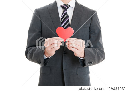 A businessman of a suit holding a heart 19883681