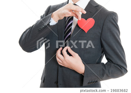 A businessman of a suit holding a heart A businessman of a suit holding a heart 19883682