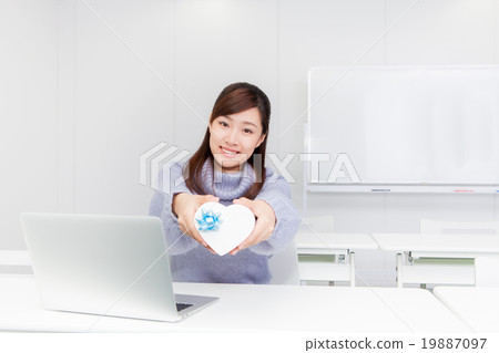 A woman with a heart-shaped gift box A woman with a heart-shaped gift box 19887097
