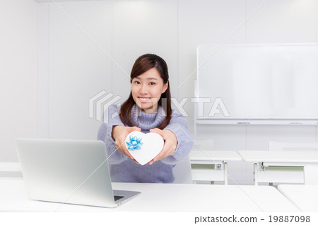 A woman with a heart-shaped gift box A woman with a heart-shaped gift box 19887098