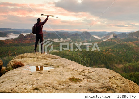 Alone tourist with poles in hand. Sunny spring 19890470