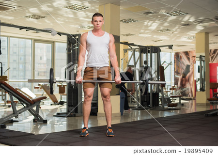 Young sportsman in gym. Young sportsman in gym. 19895409