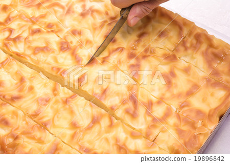 Hand cut with a knife traditional Bulgarian pie in Hand cut with a knife traditional Bulgarian pie in 19896842