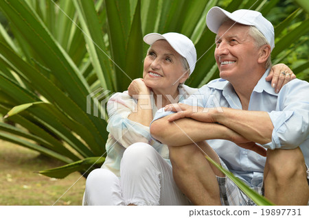 Elderly couple in tropical garden Elderly couple in tropical garden 19897731