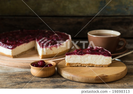 Slice of cheesecake with cup of tea on the table 19898313