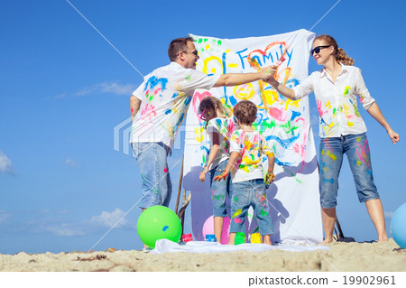 Happy family playing on the beach at the day time. 19902961