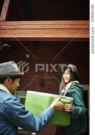 Men handling a cooler box 19906396