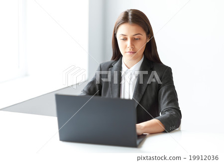 Portrait of young pretty business woman with laptop in the offic Portrait of young pretty business woman with laptop in the offic 19912036