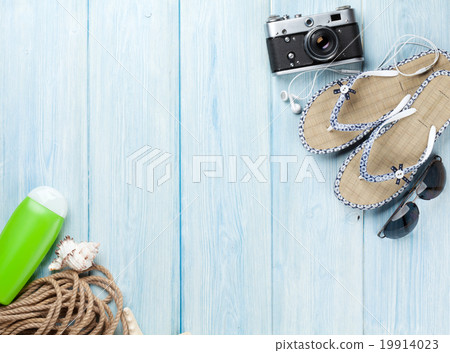 Travel and vacation items on wooden table Travel and vacation items on wooden table 19914023