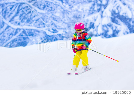 Little girl skiing in the mountains Little girl skiing in the mountains 19915000