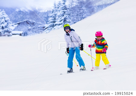 Kids skiing in the mountains Kids skiing in the mountains 19915024