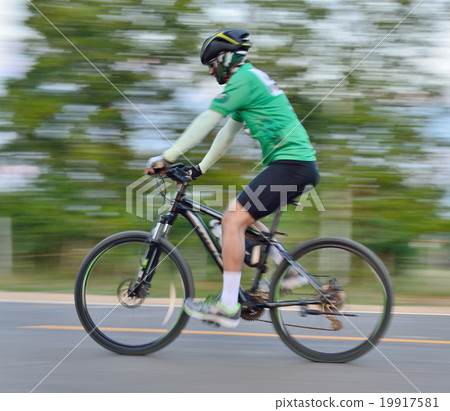 Riding a bike on a street  motion blur 19917581