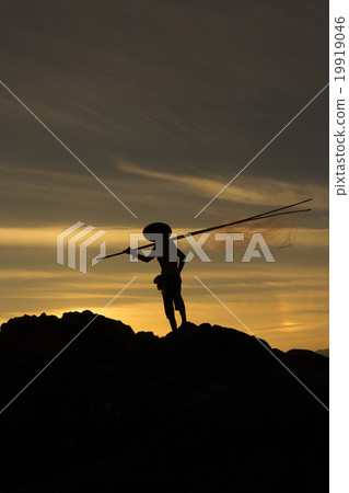 Fisherman action on stone sunset 19919046