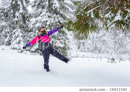 Blonde young woman standing in winter forest Blonde young woman standing in winter forest 19931500