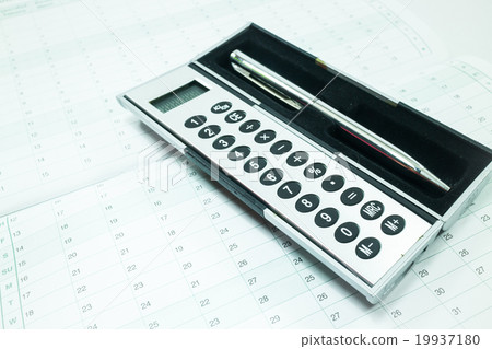 Pocket calculator and pen on the table Pocket calculator and pen on the table 19937180