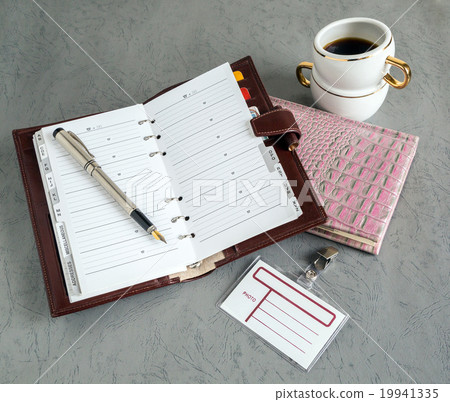 books, pens, badge, coffee 19941335