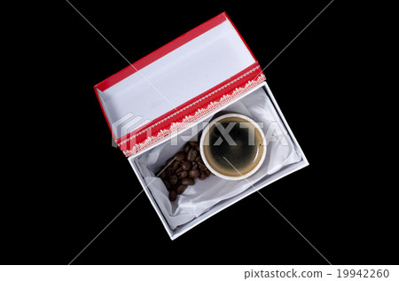 a cup of coffee in a gift box on a black background 19942260