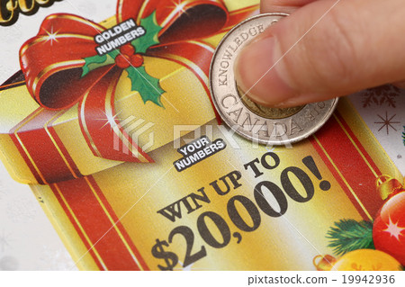 Woman scratching lottery ticket 19942936