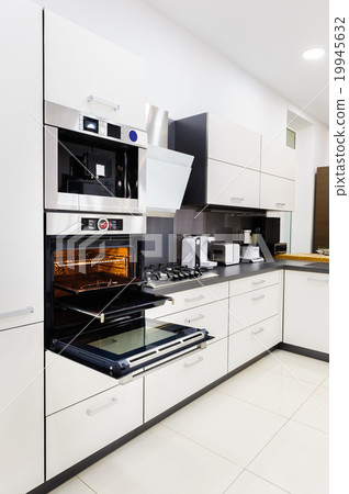 Modern hi-tek kitchen, oven with door open 19945632