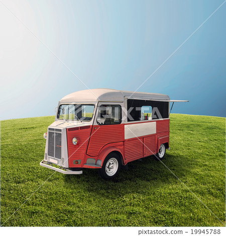Red food truck on the green field 19945788