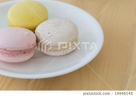 Tasty Sweet Macaroons on wooden background. 19946548