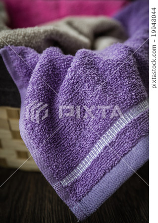 Colorful Towels in Wicker Basket Colorful Towels in Wicker Basket 19948044