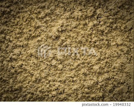 Yellow knobby cement wall for background 19948332