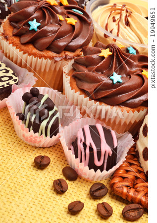 Chocolate sweets, muffins and coffee grains Chocolate sweets, muffins and coffee grains 19949651