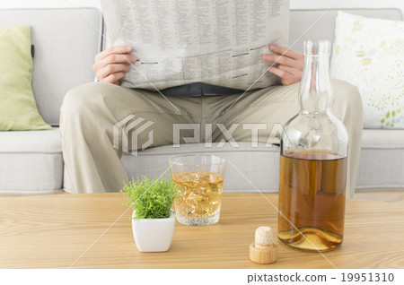 Drinking while reading a newspaper Drinking while reading a newspaper 19951310