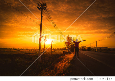 Silhouette Man on the road with relax at sunset. 19952157