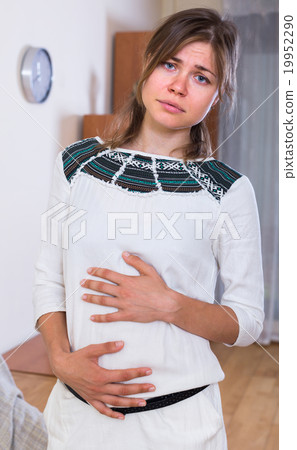 Young woman with abdominal pain Young woman with abdominal pain 19952290