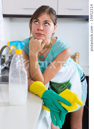 Woman tired during cleanup at kitchen. 19952314