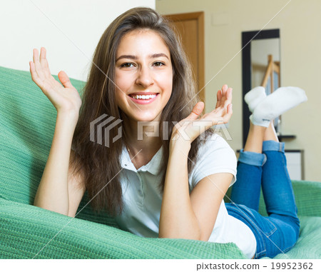 Smiling teenager girl on the couch . Smiling teenager girl on the couch . 19952362
