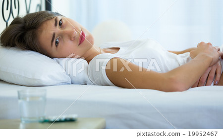 Teenage girl having belly pain and taking pills Teenage girl having belly pain and taking pills 19952467