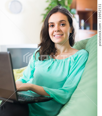 Young girl using laptop at home Young girl using laptop at home 19952531